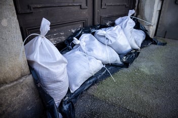 storm sandbags lined up against door