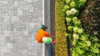 gardener scraping mulch in retail landscaping