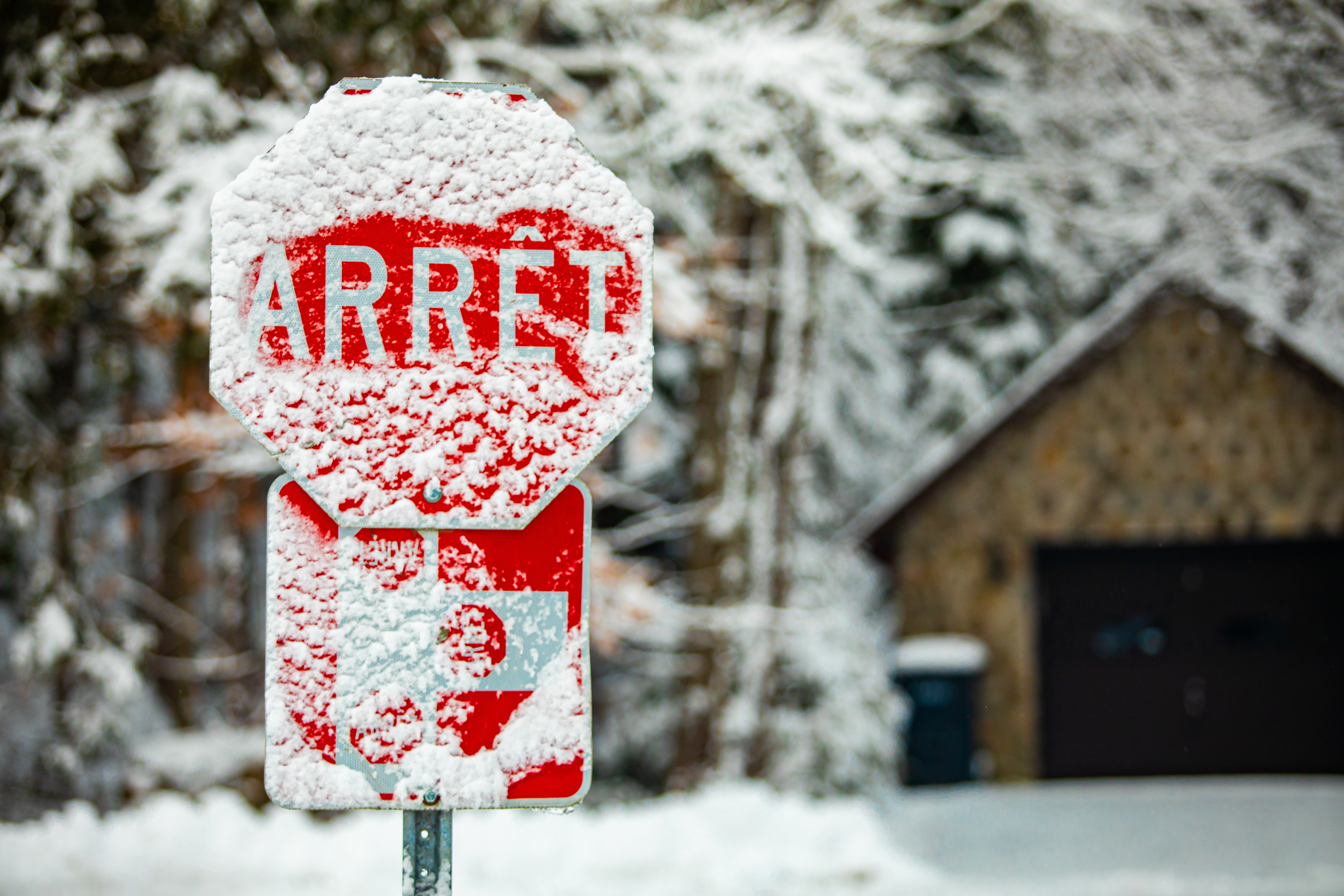 snow covered French Canadian stop sign